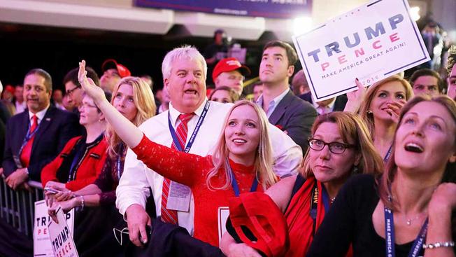People celebrate on election night in New York as Donald Trump is called as the winner. Presidential transition experts say no huge wave of staffers will head to Washington right away.